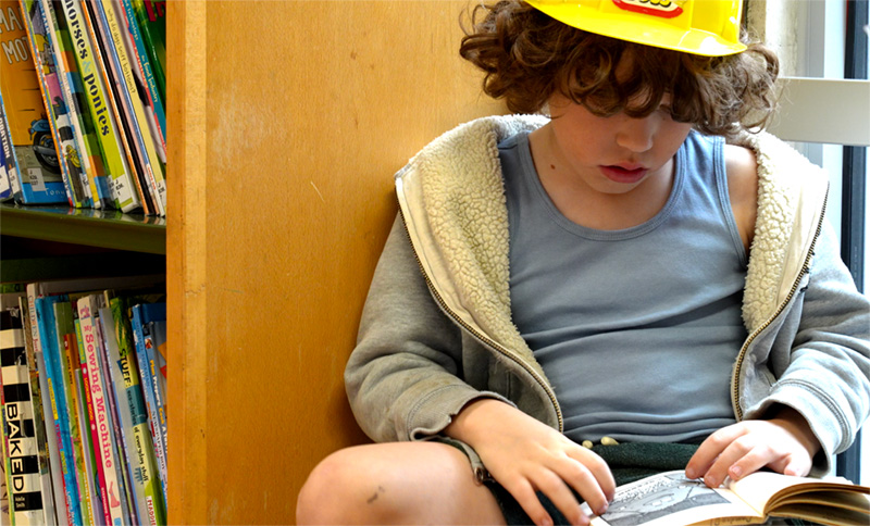 Child reading in Swiss Cottage Library